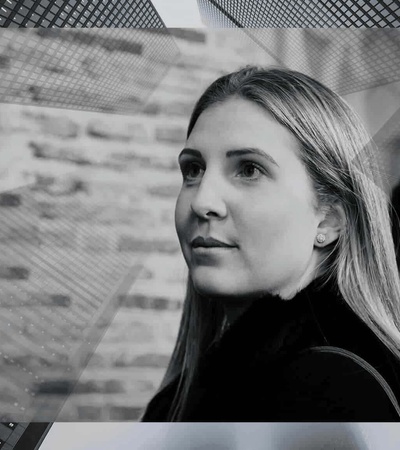 Black and white portrait of a young woman with a contemplative expression, set against a geometric-patterned background.