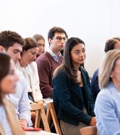 A focused group of people attentively listening to a presentation.