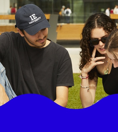 A group of young adults engaging in a lively conversation outdoors.