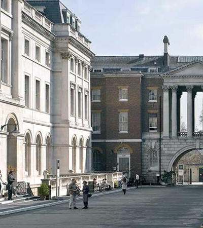 A historical architectural scene featuring classical buildings and an archway.