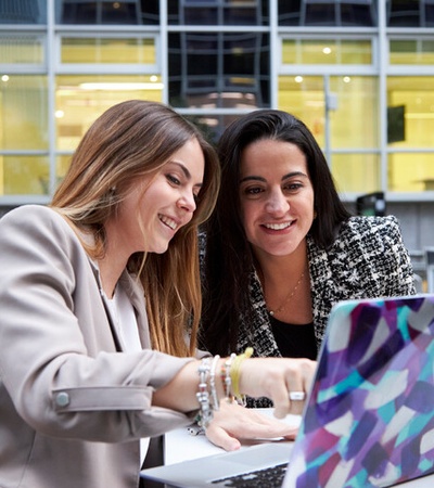 Laidlaw - two woman speaking looking a laptop