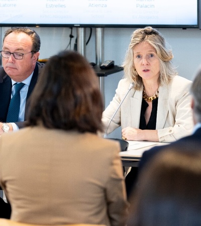 A group of professionals sitting at a conference table during a meeting.