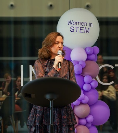 A woman speaking at an event promoting women in STEM.
