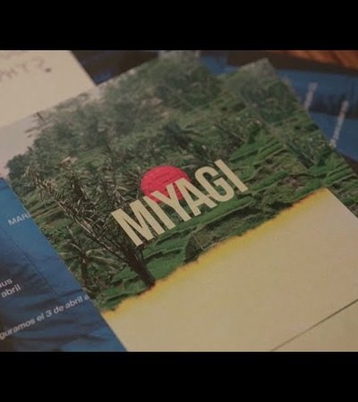 A promotional postcard featuring the word 'MIYAGI' against a backdrop of lush greenery.
