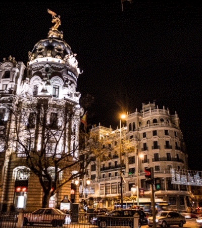 A night view of a beautiful cityscape with illuminated buildings and bustling traffic.