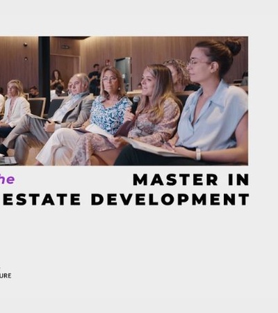 A group of people attending a presentation about a Master's program in Real Estate Development.