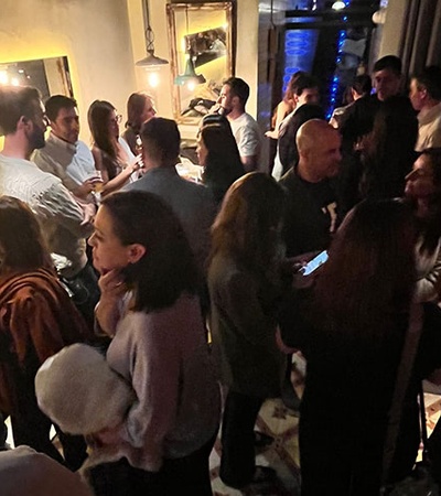 A lively social gathering taking place in a dimly lit venue.