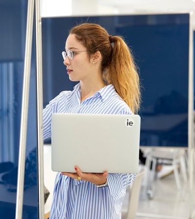 IE Student with computer and board