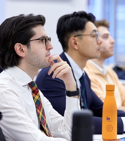 A group of students attentively listening in a classroom setting.