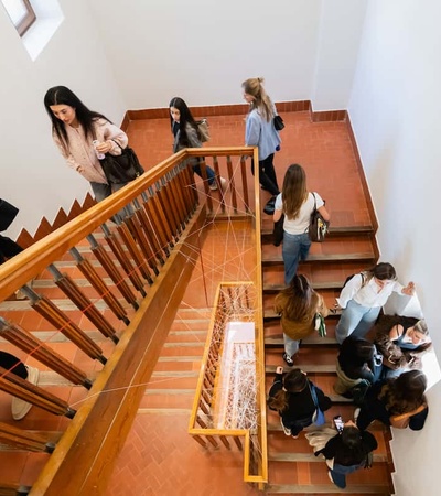 A group of people walking down a staircase in a bright, modern building.