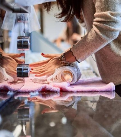 A person receiving a manicure at a nail salon