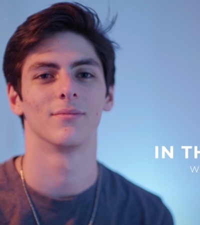 A young man is pictured in a promotional banner for a program titled 'In Their Shoes' with Samer Roz.