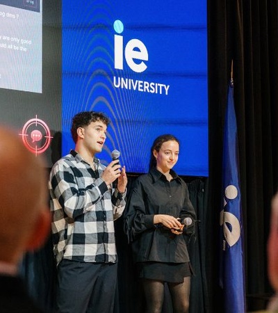 Two students are presenting at an event at IE University.