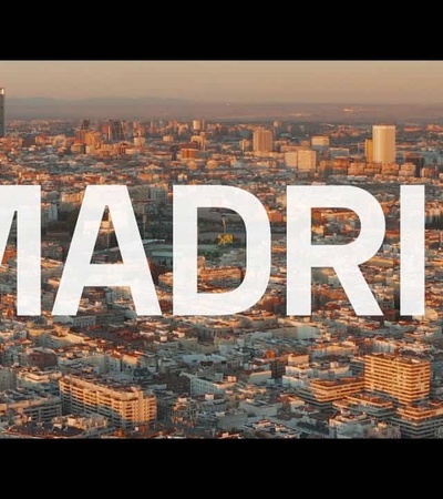 Aerial view of Madrid with the word 'MADRID' superimposed in large letters.