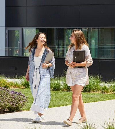 Two IE Student walking across IE Madrid campus