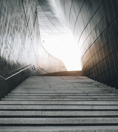 A staircase leading towards a bright light at the top.