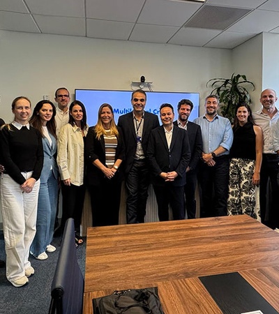 A group of professionals posing together in an office setting.