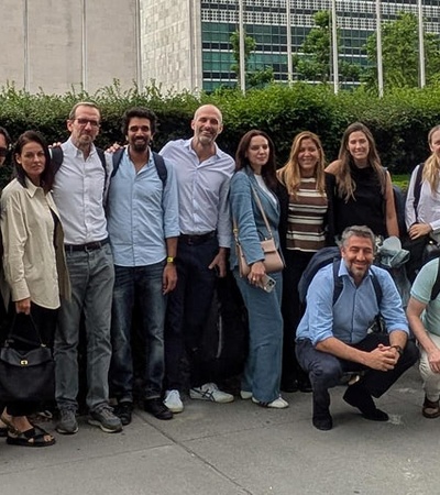A group of people posing together outside a building.