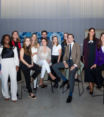 A group of people posing for a photo in a semi-formal event setting.