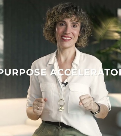 A woman confidently presenting a concept related to purpose acceleration.