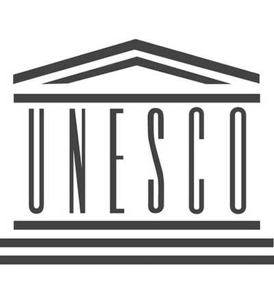 The logo of UNESCO featuring a stylized representation of a building.