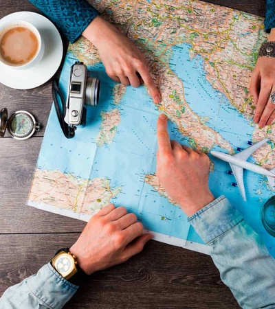 Map with hands, a coffee an plane