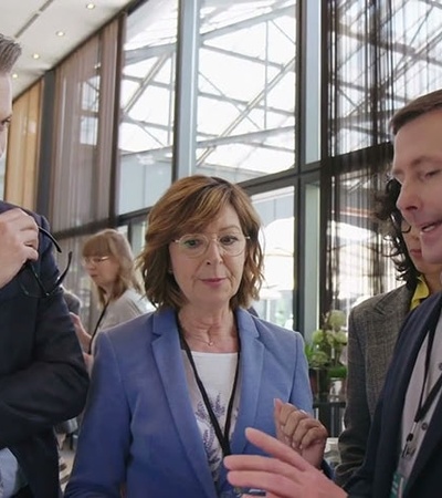 A group of professionals discussing a project in a modern office environment.