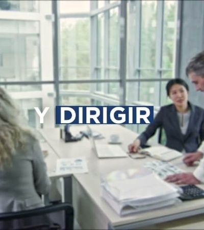 A group of professionals gathered around a table during a business meeting in a modern office.