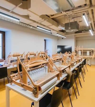 A bright and modern workshop space featuring wooden models on tables.