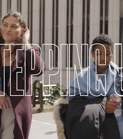 Two young people walking outdoors in an urban setting.