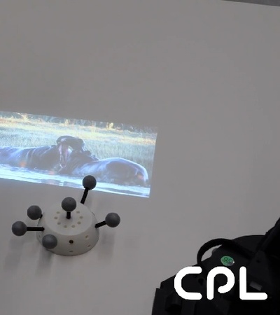 An educational setup showcasing a hippo book with a projected image of hippos.