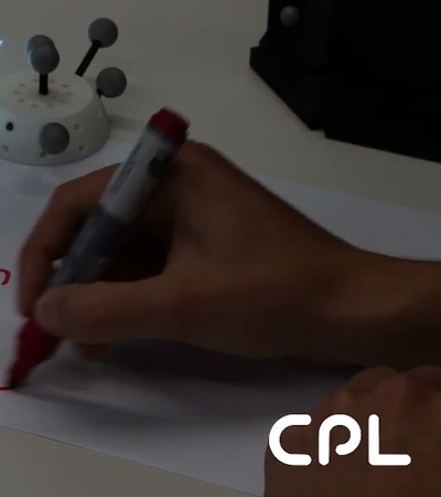 A person is solving a math equation involving the variable x on a white sheet of paper.
