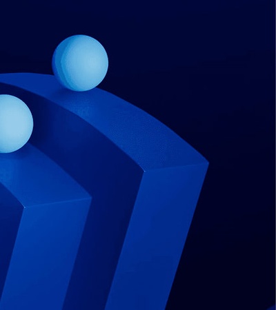 This image features three spherical objects positioned on a series of curved surfaces, all in shades of blue.