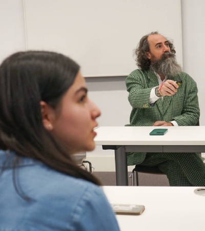 A group of people engaged in a discussion in a classroom setting.