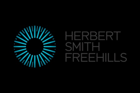 Logo of Herbert Smith Freehills featuring a circular geometric design next to the company name in white text on a black background.