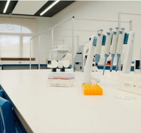A modern laboratory workspace with lab equipment and supplies arranged on a clean table.