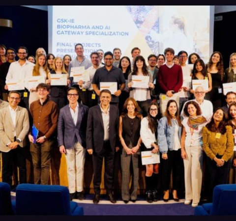 A large group of people posing together at a graduation or award ceremony.