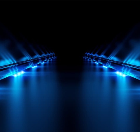 A futuristic scene with glowing blue lines converging in the distance on a dark background.