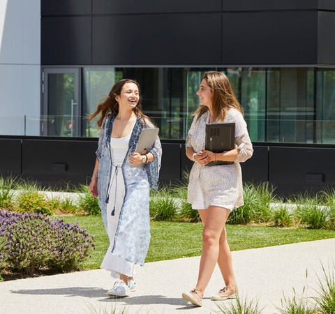 Two IE Student walking across IE Madrid campus