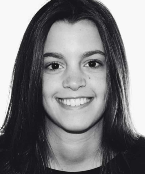 Black and white portrait of a smiling young woman with long straight hair.