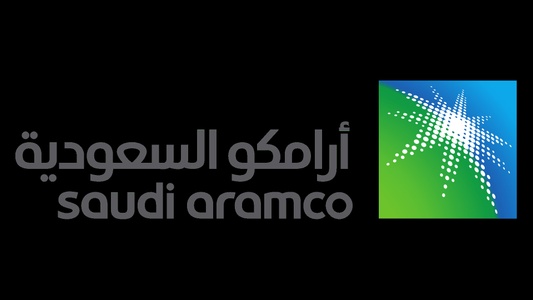 Logo of Saudi Aramco featuring its name in both Arabic and English next to a stylized green and blue dot graphic.