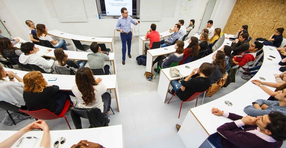 A group of students attending a presentation in a modern classroom.