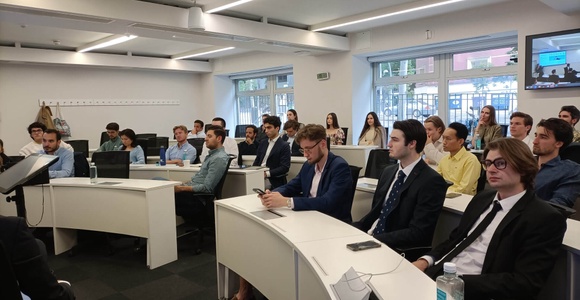 A group of professionals attending a presentation in a modern conference room.
