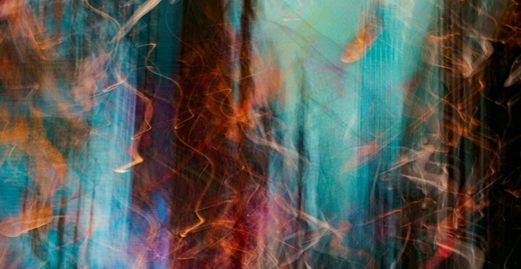 Abstract blurred motion of lights with a blend of blue, orange, and white colors creating a dynamic and artistic effect.