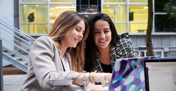 Laidlaw - two woman speaking looking a laptop