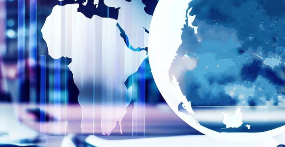 on a wooden table there are fountain pens and reports while the hologram of the continents of planet earth can be seen.