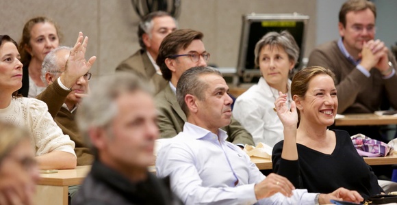 A diverse group of people engaged in a discussion at a conference.