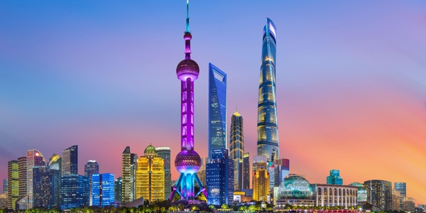A stunning skyline view of Shanghai at sunset featuring iconic skyscrapers.