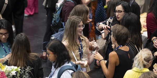 A group of women engaging in conversation at a networking event.