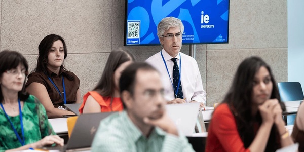 A group of people attending a seminar or lecture in a university setting.